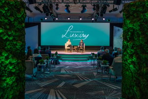 Two speakers sitting on stage discussing the business of luxury